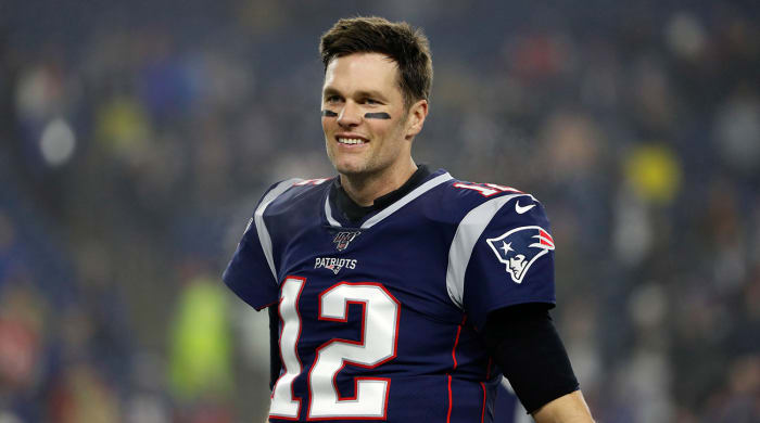 Tom Brady in a Patriots jersey with no helmet on